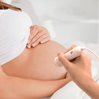 pregant woman using fetal heart rate monitor